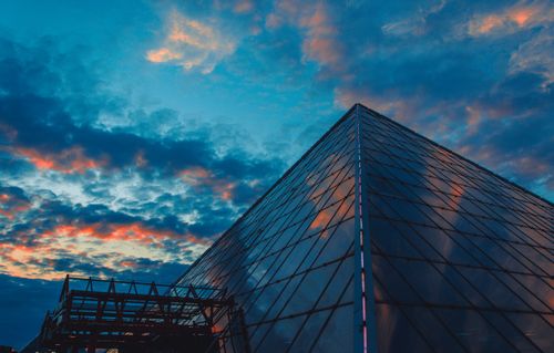 Free Stunning view of a glass pyramid structure in Viciebsk, Belarus, under a dramatic sunset sky. Stock Photo