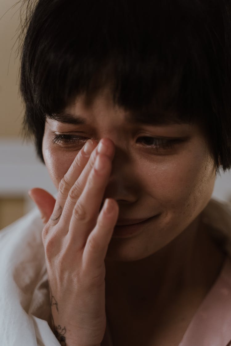 A Sad Woman Wiping Her Tears