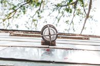 Silver Round Ornament on Gray Wooden Plank