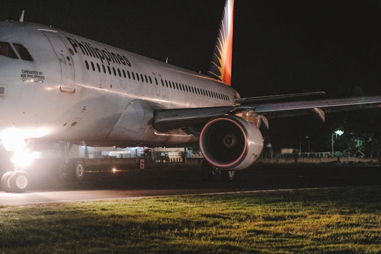 Commercial Plane Parked On An Airport At Night 