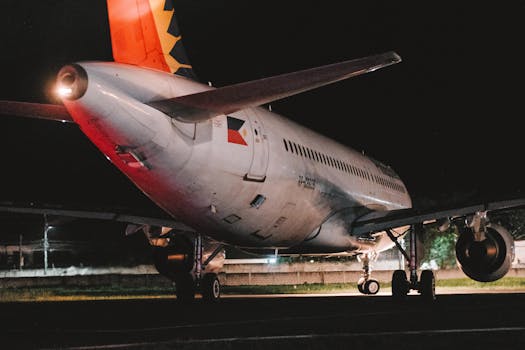 Airplane parked on a tarmac at night, showcasing aviation technology in the Philippines.