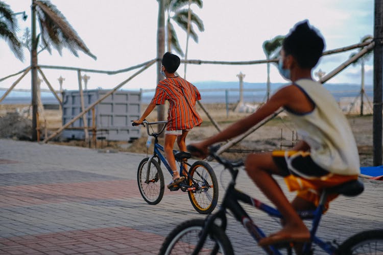 Kids In Face Masks Riding Their Bikes 