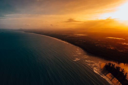 Breathtaking aerial view of Balok Beach at sunset in Pahang, Malaysia, showcasing the coastline and vibrant sky.
