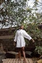 Woman in a White Dress Shirt Posing at a Backyard