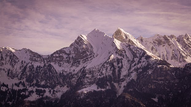 A stunning view of the snow-covered Swiss Alps mountains under a winter sky from Walenstadt, Switzerland.