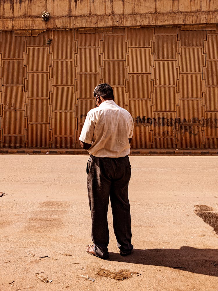 Ethnic Man Standing Near Old House