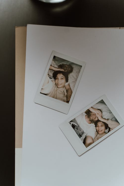 Polaroid Pictures of a Couple Lying on White Background 