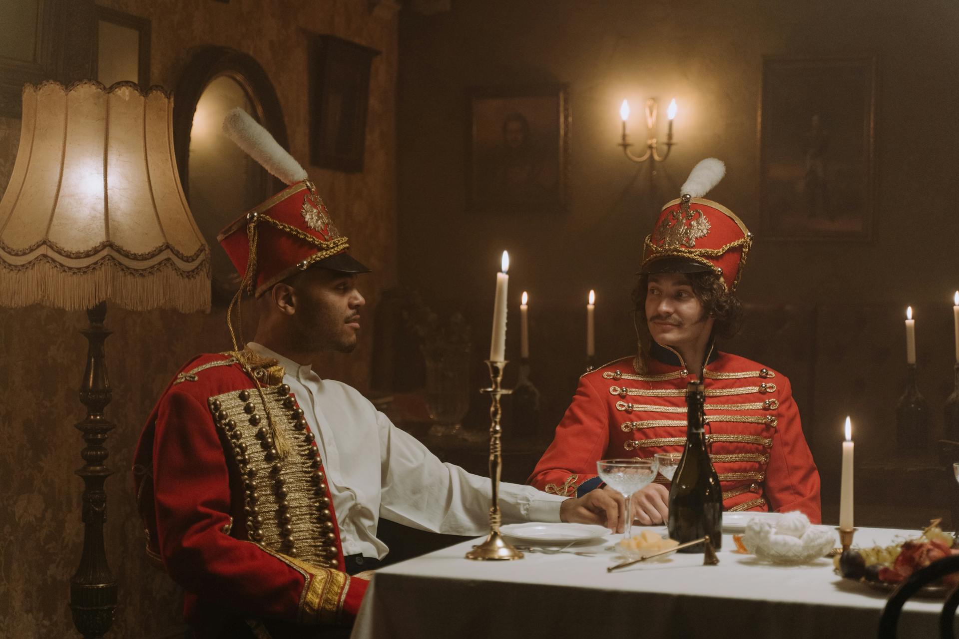 Men in British Military Costumes Sitting by the Table