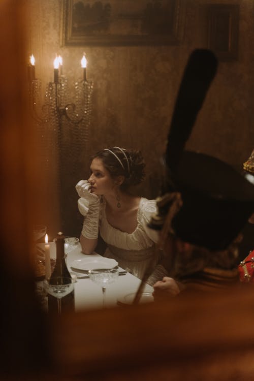 Woman Sitting at Table with Place Setting