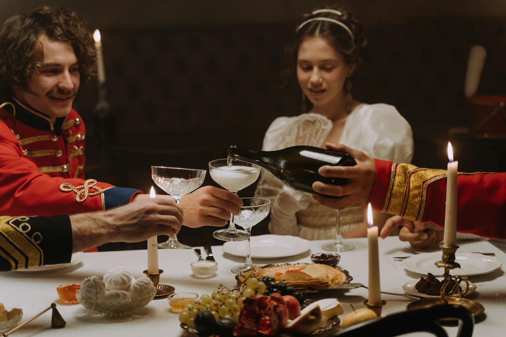 Group of People Dressed as Aristocracy Sitting at the Table and Dining