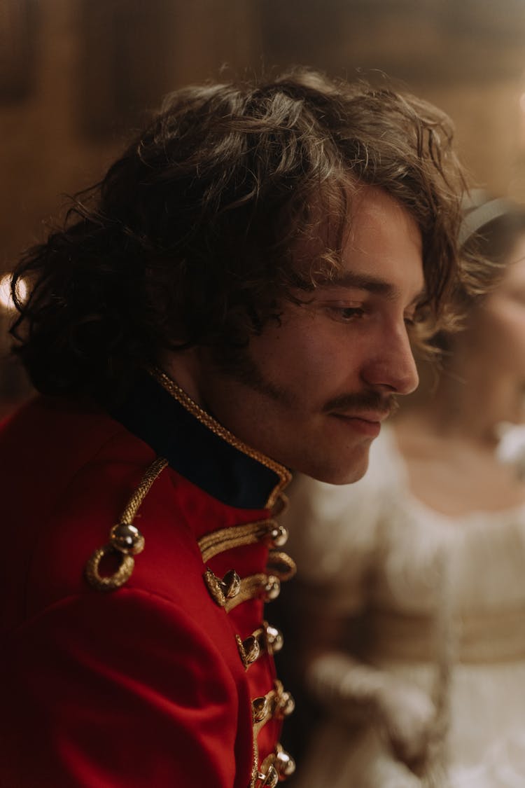 Close Up Shot Of A Person In Scarlet Tunic