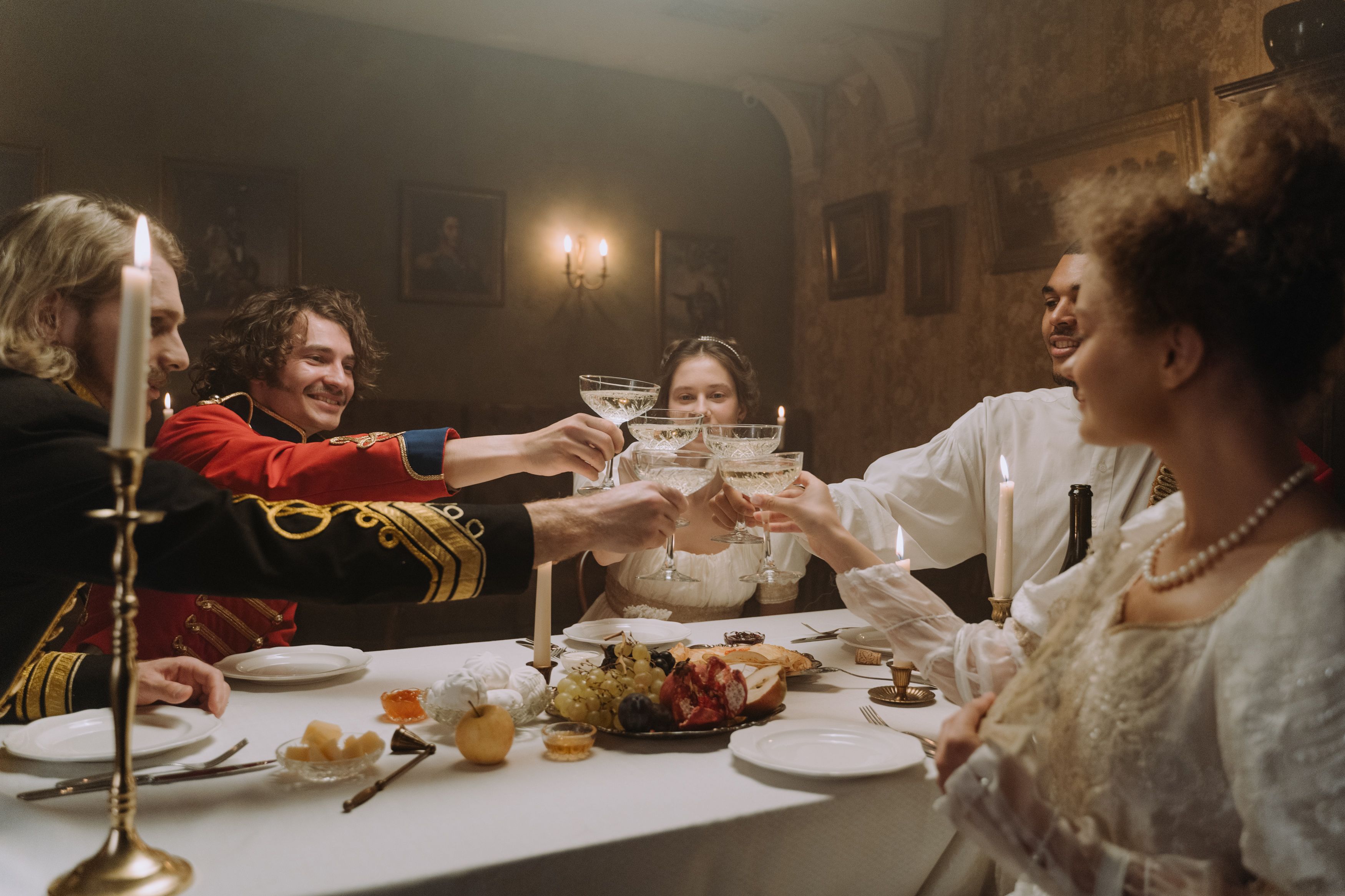 A group of diners dressed in Victorian-era attire, enjoying a meal in a beautifully decorated Victorian dining room.