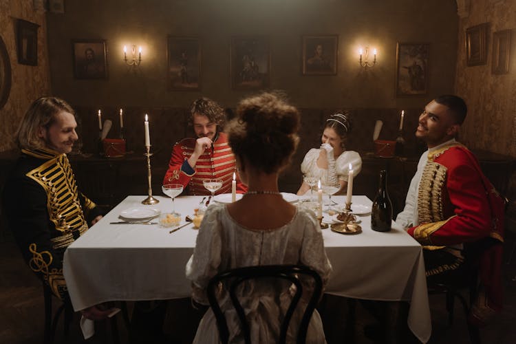 Happy People Sitting At Table 