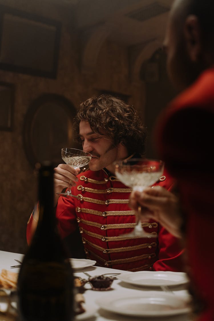 Man In Scarlet Tunic Drinking