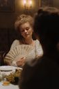 Elegant Woman Holding a Fan