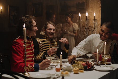 Men in British Military Costumes Sitting by the Table Having a Feast