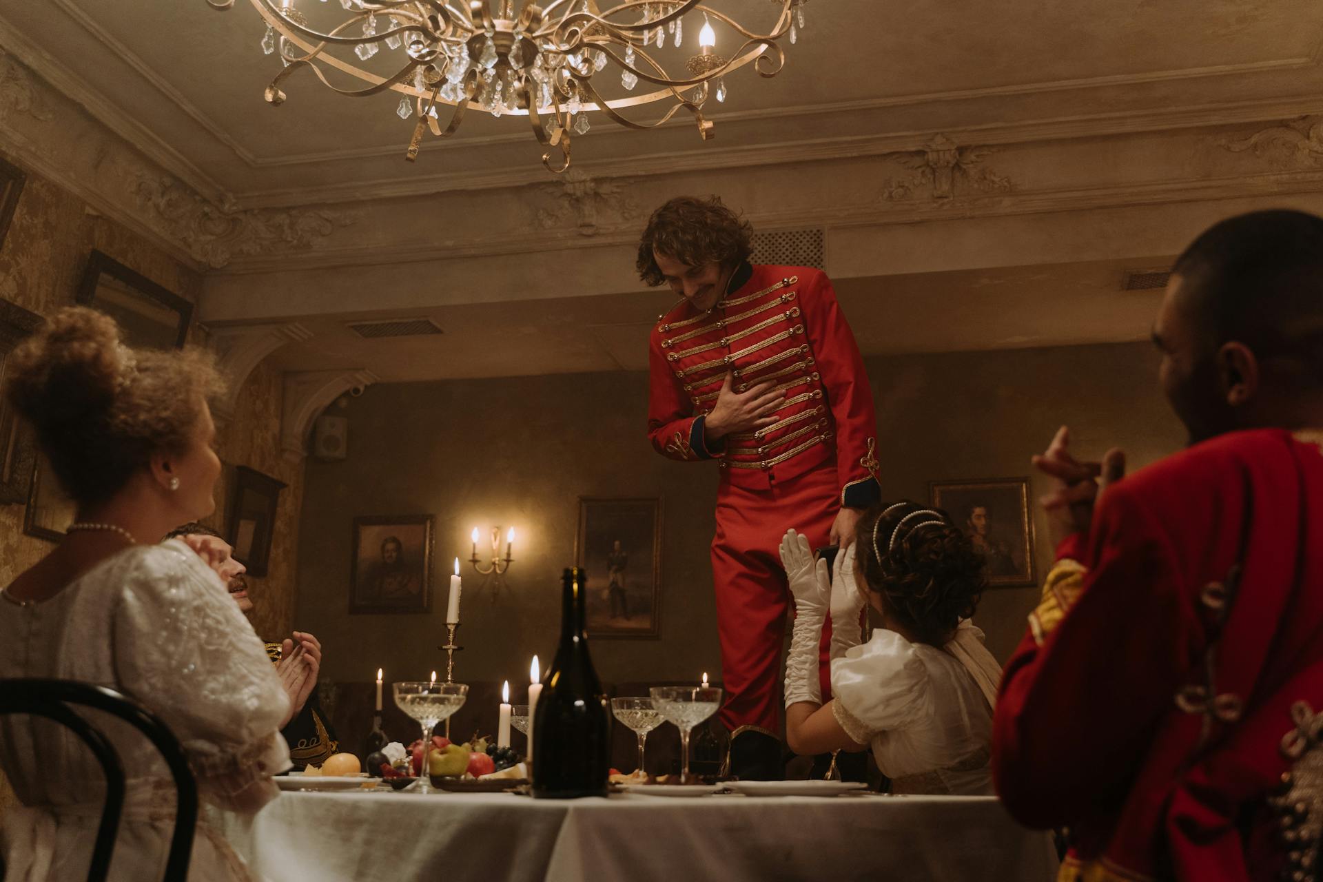 Group of People Dressed as Aristocracy Sitting at the Table and Dining