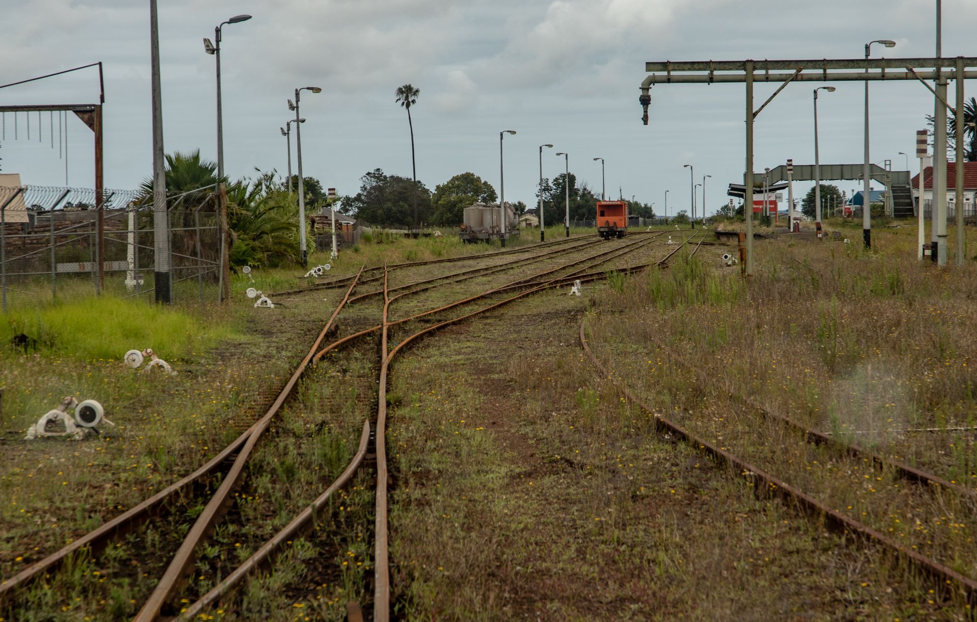 Brown Metal Train Rail on the Green Grass Field