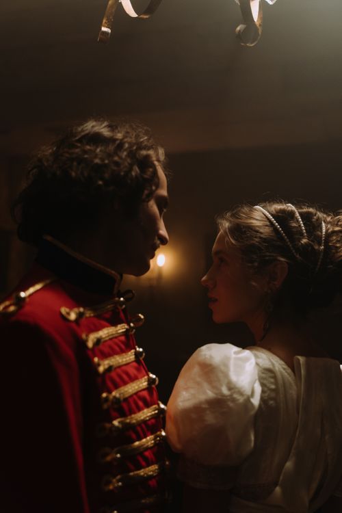 Free A couple dressed in vintage attire shares a close, intimate moment indoors, evoking historical romance. Stock Photo