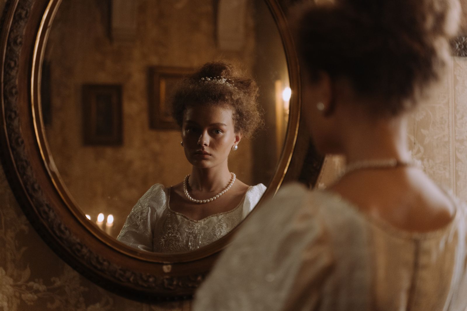 A young woman looking at herself in the mirror