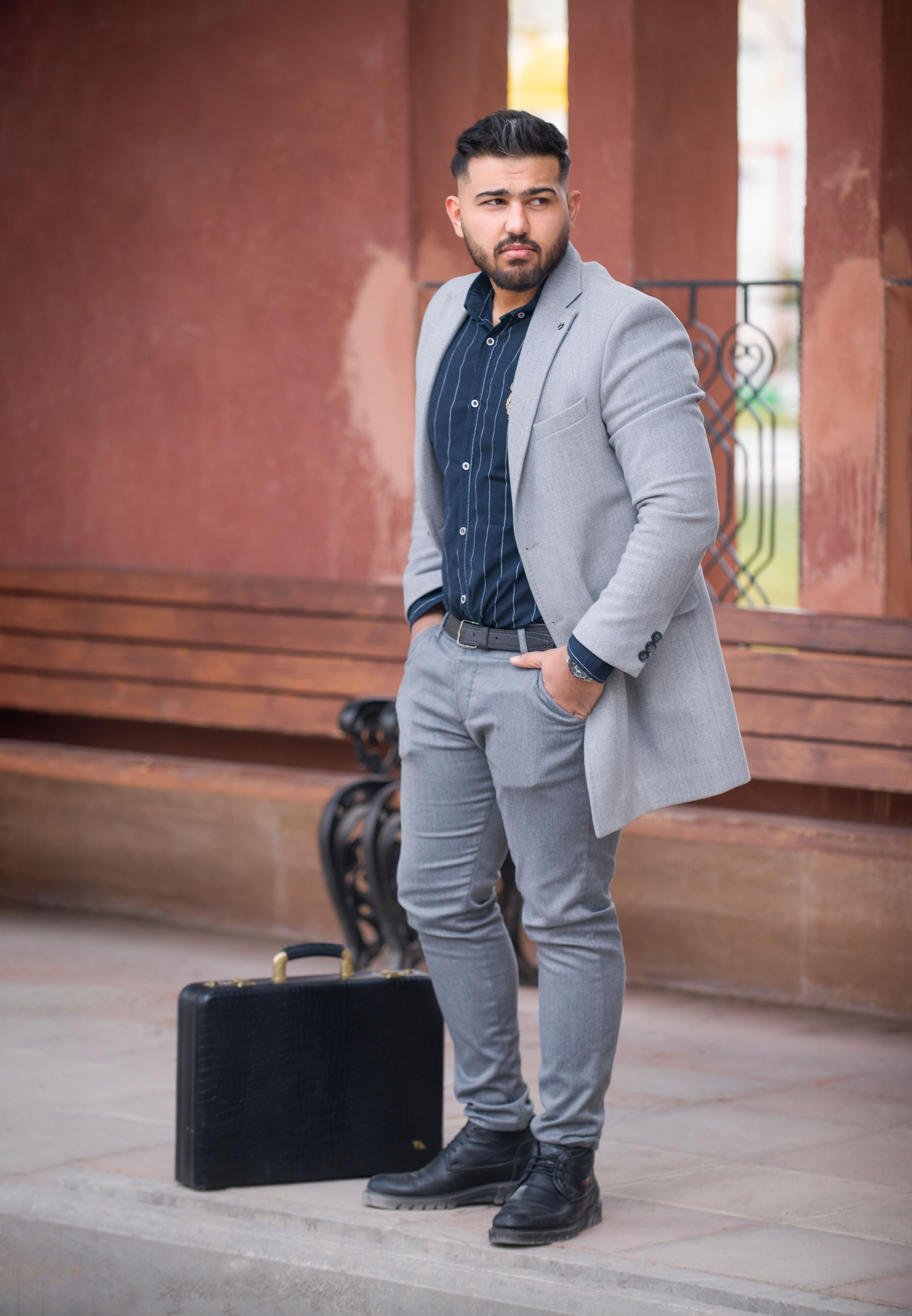 Confident businessman in Tehran with fashionable attire, ready for the day outdoors.