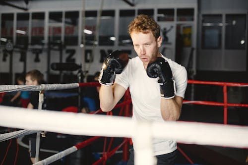 A Man Wearing Black Boxing Gloves