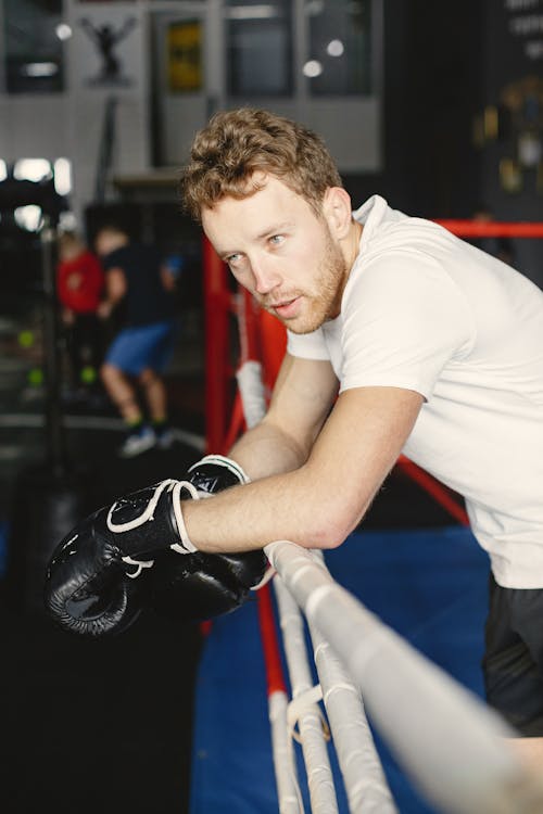 A Man Wearing Black Boxing Gloves