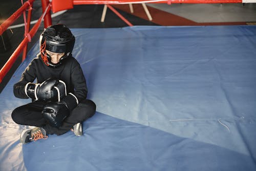 Free A Boy Sitting in the Boxing Ring Stock Photo