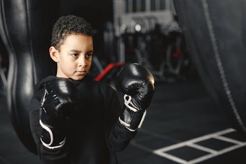 Free A Boy in Black Leather Boxing Gloves Stock Photo