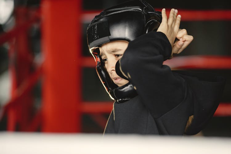 A Boy Wearing A Black Head Gear