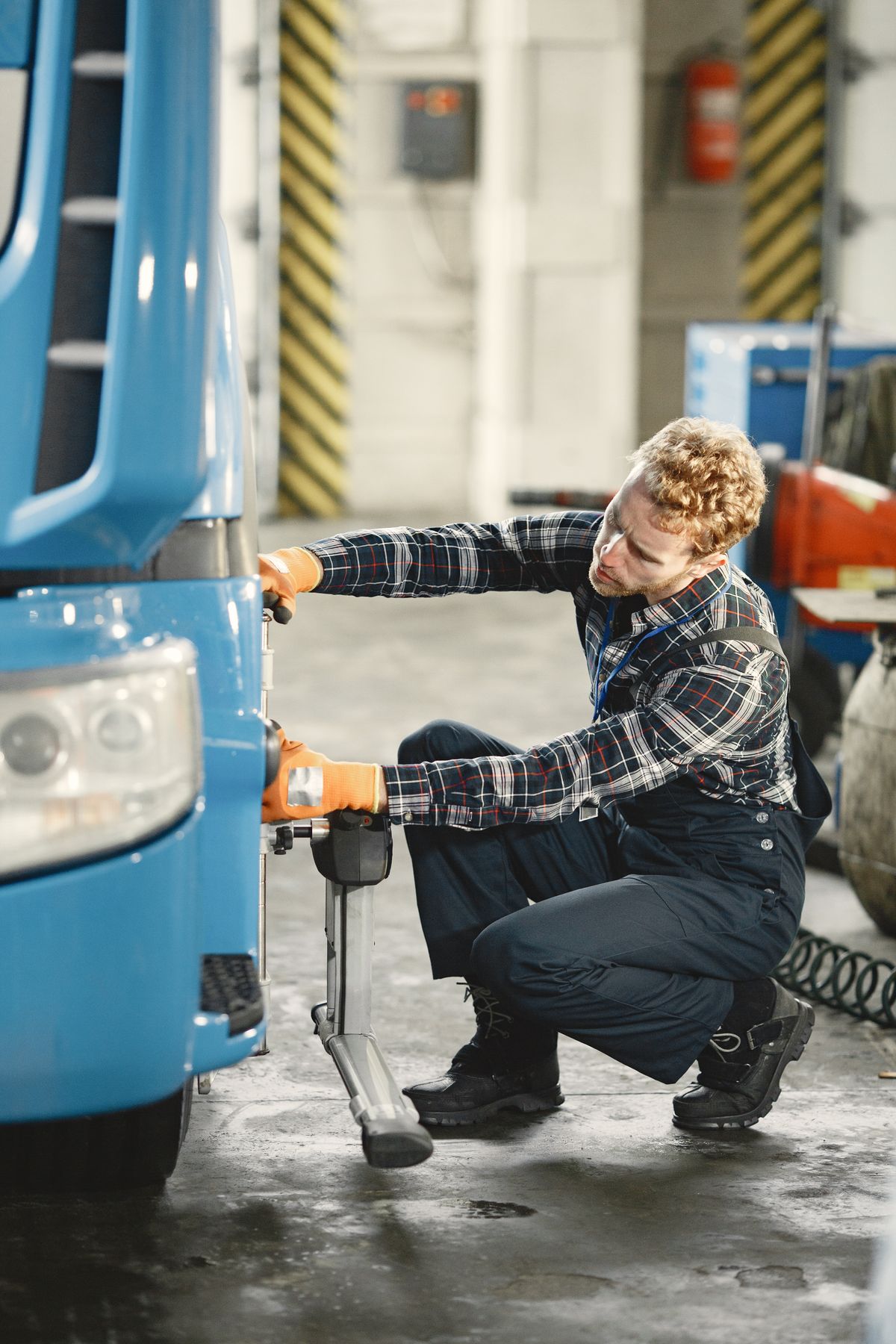 Mechanic working on a truck with tools and equipment