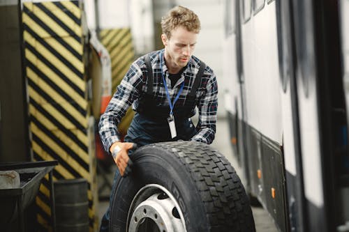 A Man Holding a Tire