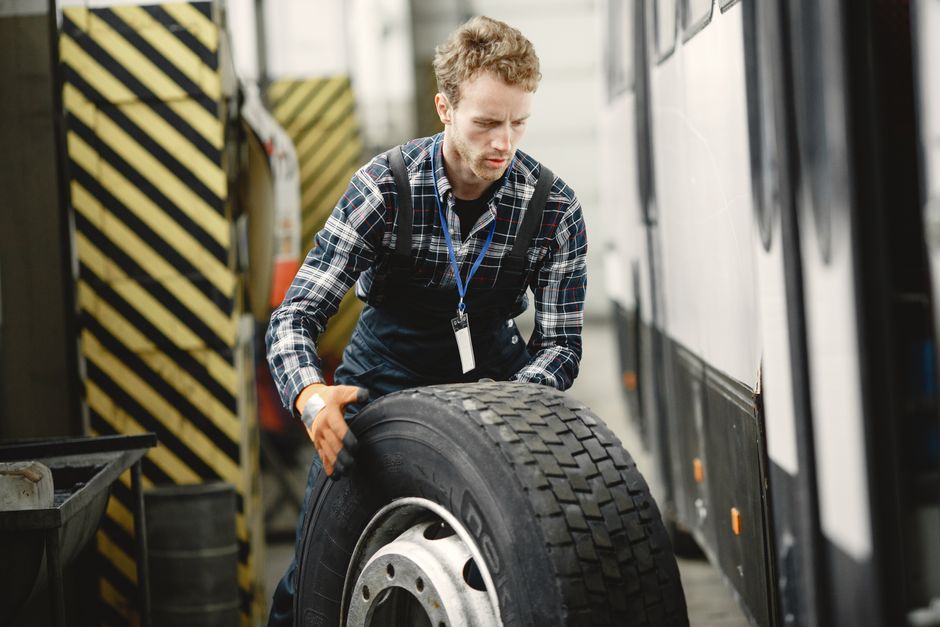 A technician balancing a tire on a professional balancing machine A technician balancing a tire on a professional balancing machine