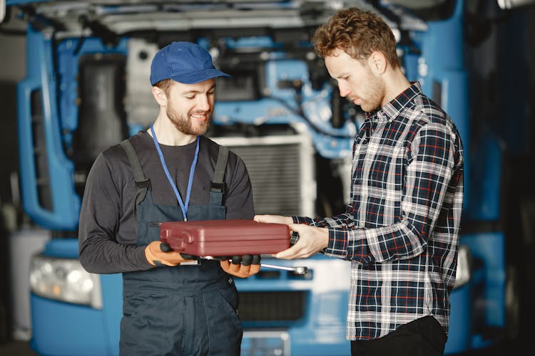 Men Holding A Toolbox