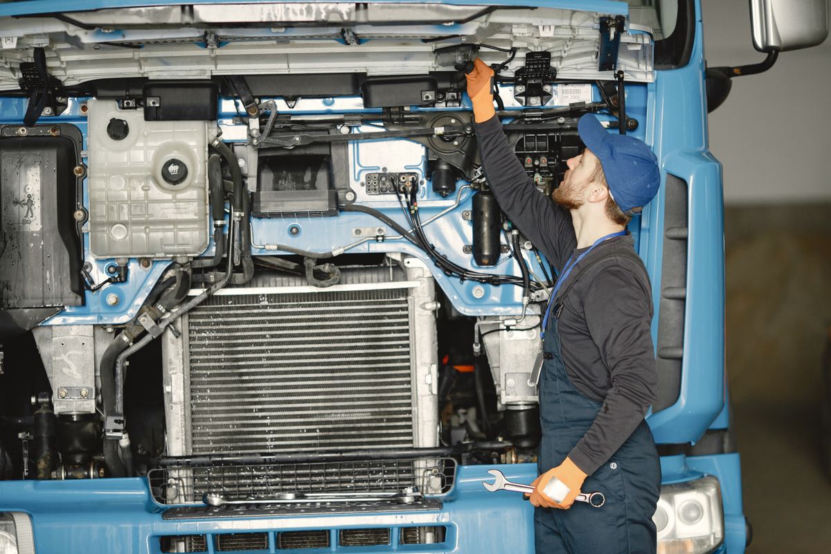 Mechanic checking a heavy truck engine