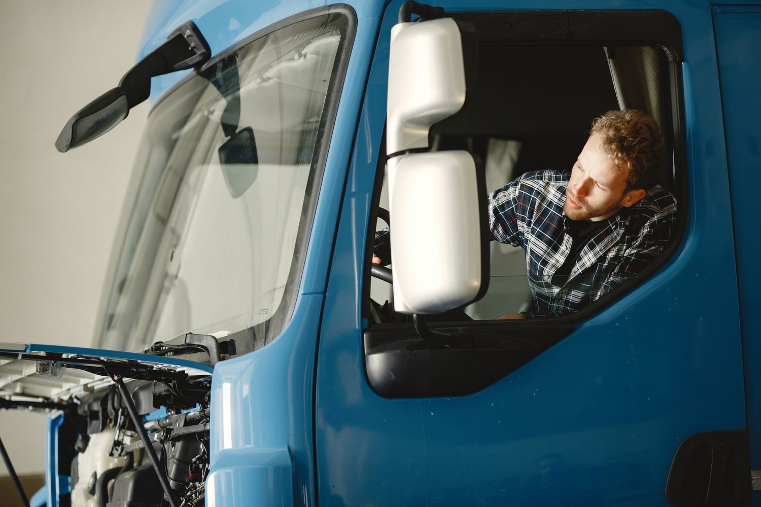 Mechanic inspecting a truck engine
