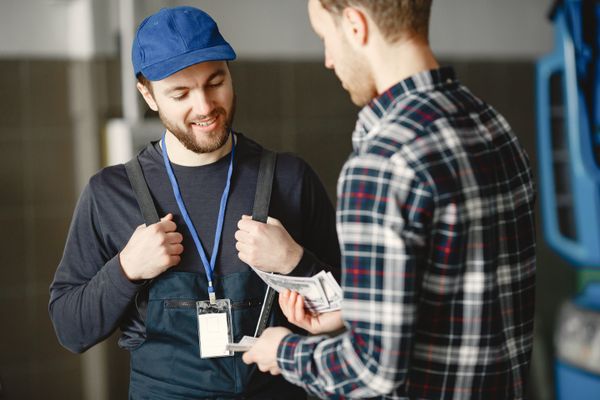 Plumber talking a customer through the options for a repair on site