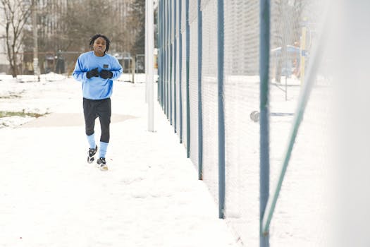A man jogging outdoors in winter snow for exercise and healthy lifestyle.