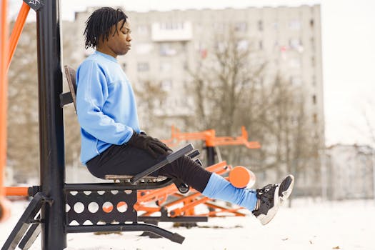 Man exercising at an outdoor gym in winter, building strength and resilience.