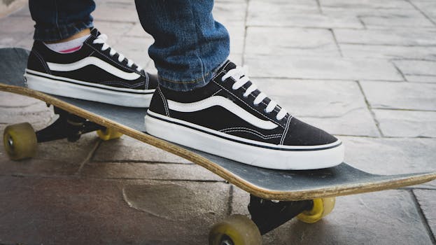 Close-up of a skateboarder wearing stylish black sneakers on a skateboard. Perfect shot for urban fashion themes.