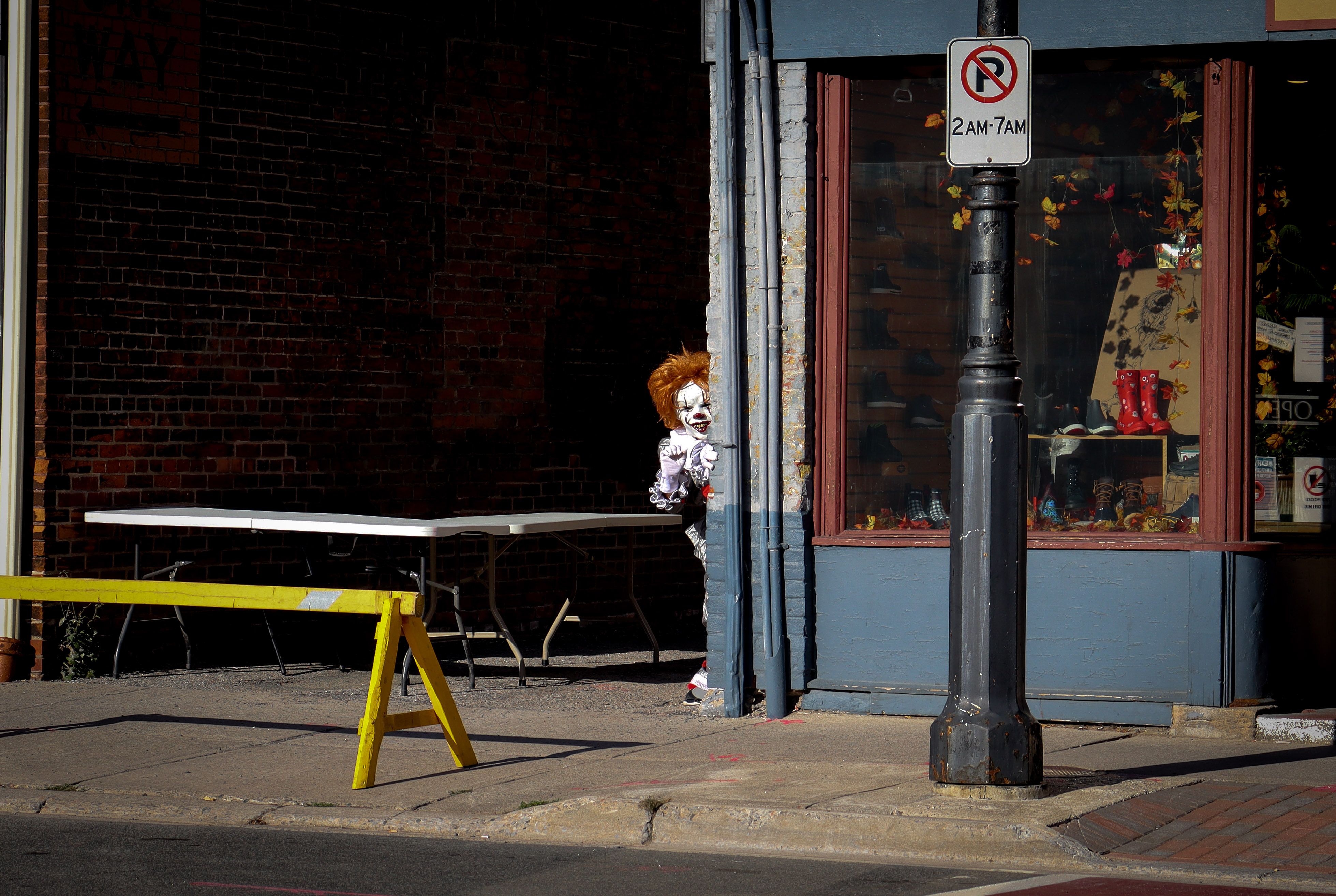 Pennywise the Dancing Clown peeking from behind a red balloon - welcome to derry