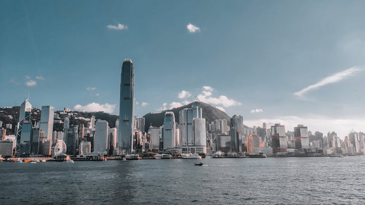 The Famous Skyscrapers Of Hong Kong With A View From Across A River