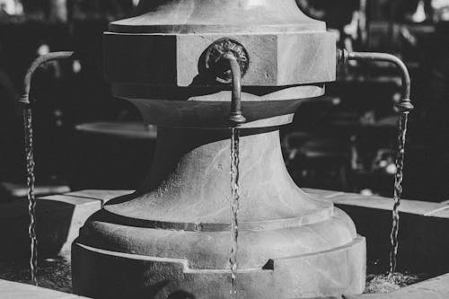 Grayscale Photo of a Water Fountain