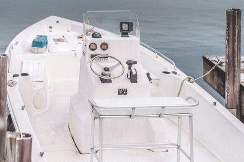 A White Motorboat Docked Beside Pier 