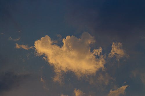 Fluffy white clouds floating in bright blue sky