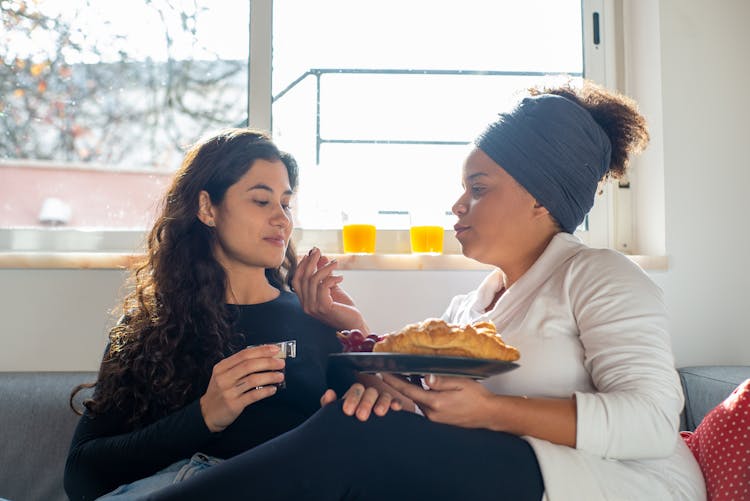 Woman Feeding Her Girlfriend Breakfast 