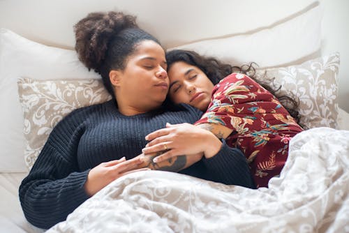Free A Couple Sleeping on the Bed Stock Photo