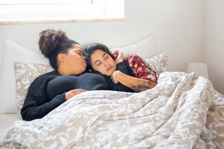 Couple Sleeping On Bed