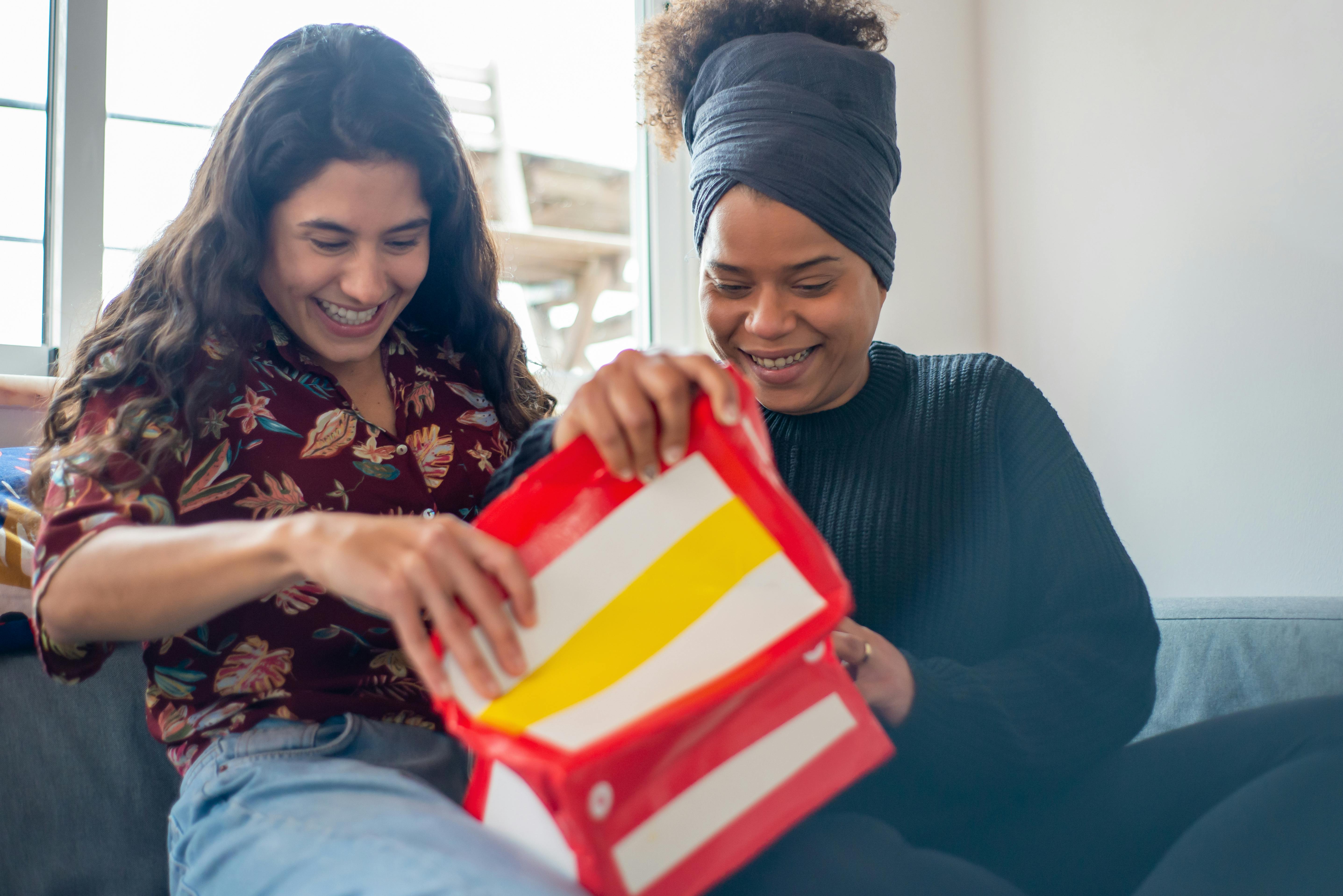 a happy couple opening a gift together