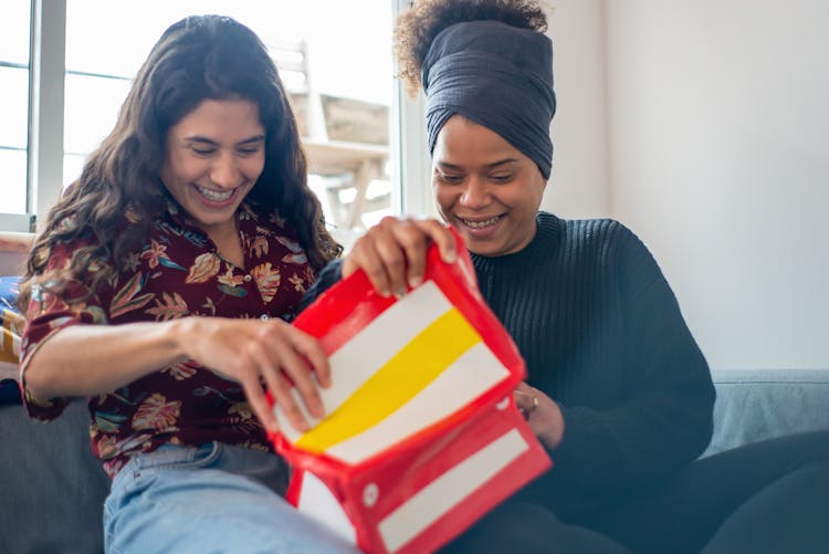 A Happy Couple Opening A Gift Together